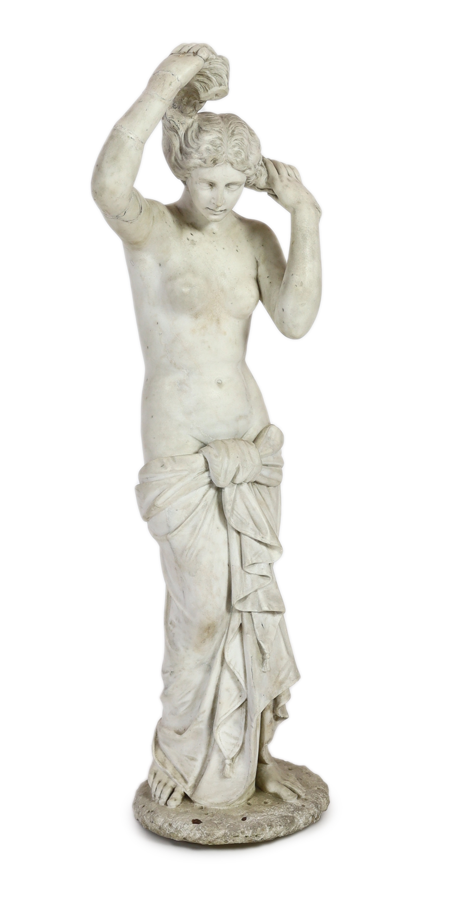 After the Antique. A late 19th century Italian carved white marble figure of Venus Anadyomene